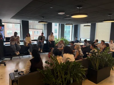 Students listening to an alumni during the NYC Trek. 